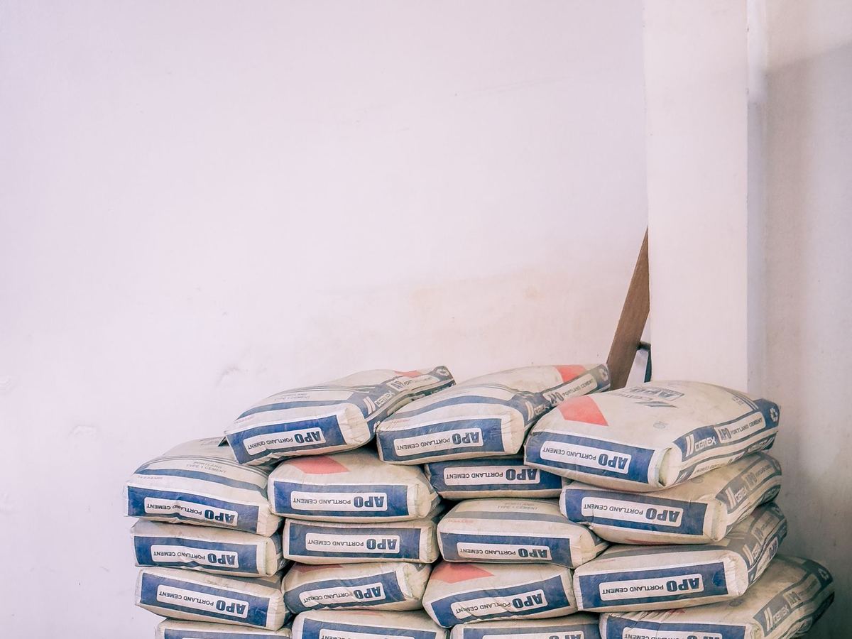 Stacked bags of cement arranged on pallets inside a warehouse